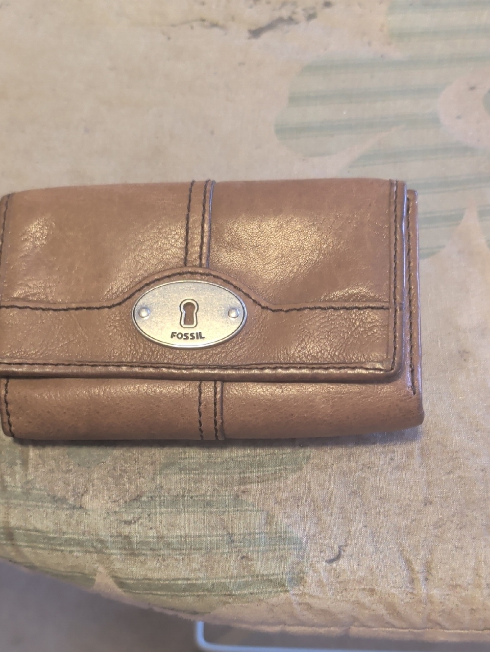 Fossil brown leather trifold wallet with silver-tone logo